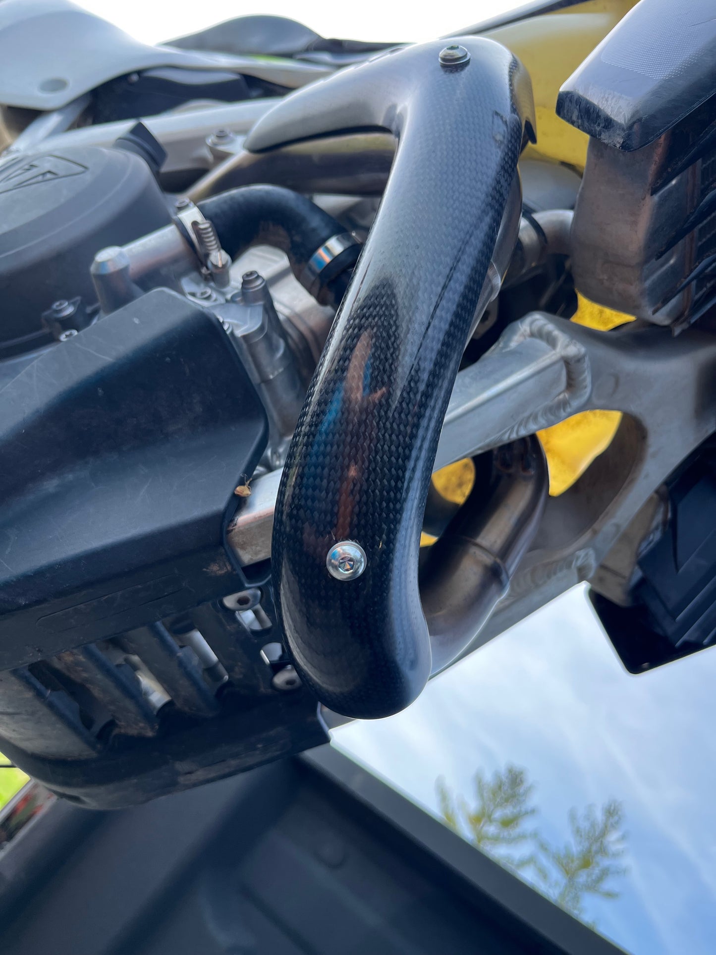 E Line Carbon Fiber Heat Shield installed on Triumph TX250E