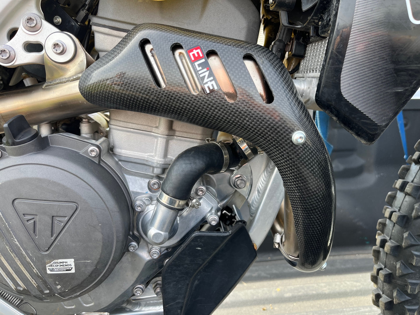 E Line Carbon Fiber Heat Shield installed on Triumph TX250E